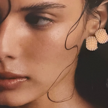 Load image into Gallery viewer, Close-up of a woman wearing gold earrings with a blurred background